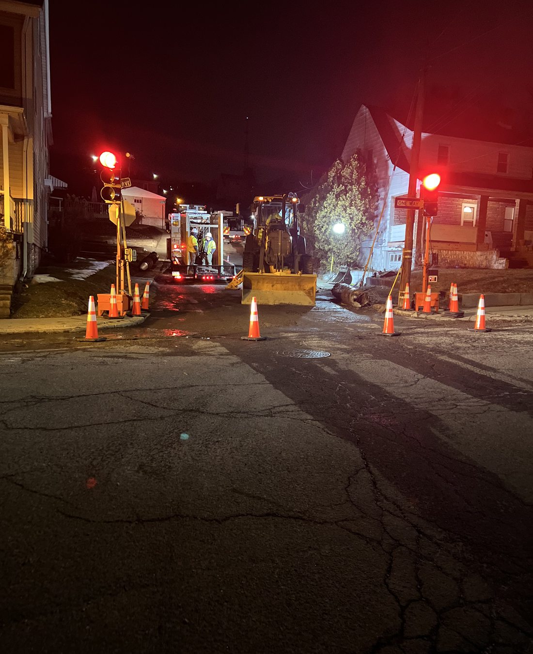 Night work zone with temporary traffic signals and utility equipment